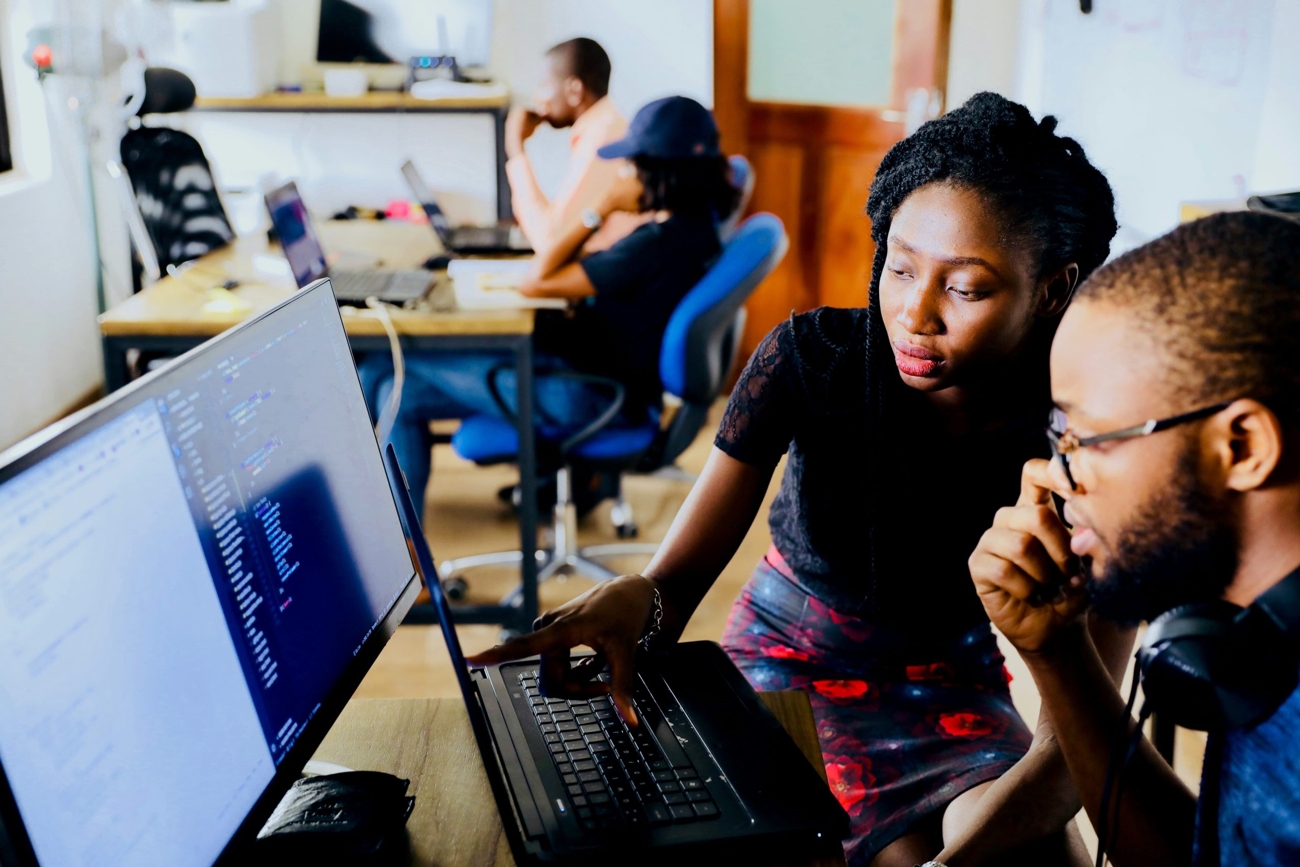 a man and woman infront of a computer